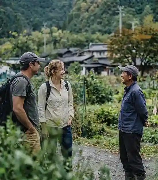 Foreign guide with mid-aged guests in a natural Yamanashi setting